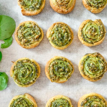 rows of spinach pesto pinwheels for baby led weaning on white background