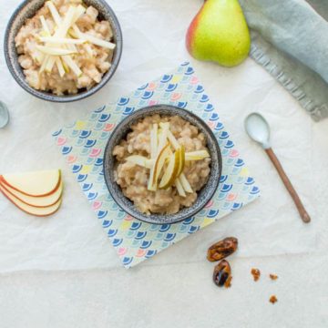 two bowls of naturally sweetened pear rice pudding with fresh pears and dates
