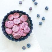 blueberry yogurt drops in circular dish with blueberries scattered around