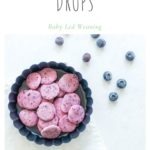 baby led weaning blueberry yogurt drops in round dish scattered with blueberries