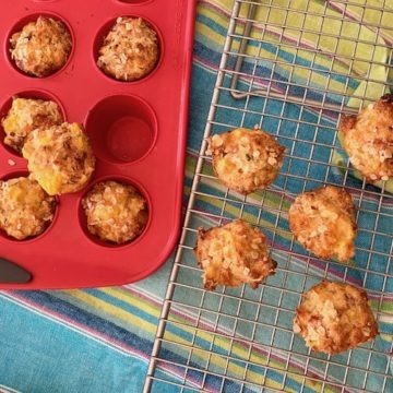 ham and cheese muffins on wire rack and in red tin
