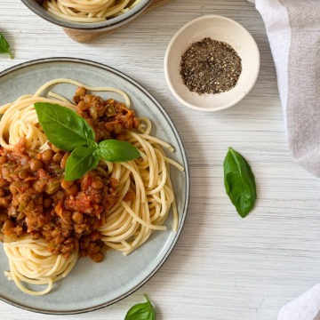 Vegan Lentil Bolognese and spaghetti topped with basil