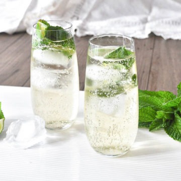 two glasses of hugo cocktail with lime and mint