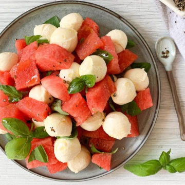 easy watermelon salad recipe with basil and mozzarella on blue plate