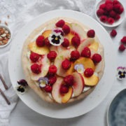 peach melba almond meringue gateau with fresh raspberries and peaches