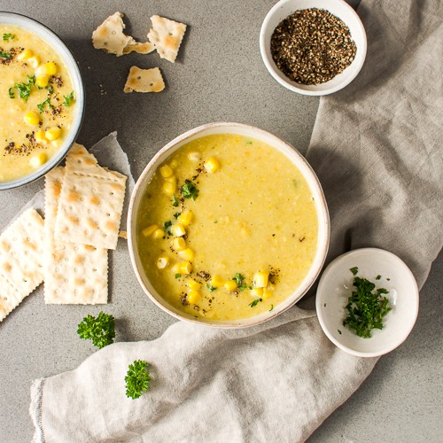 Bowl of sweetcorn leek chowder with crackers