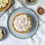 easy banoffee pie in centre of picture with half made pie on cooling rack to the left