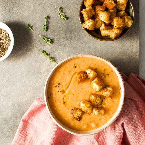 Bowl of tomato and lentil soup with croutons