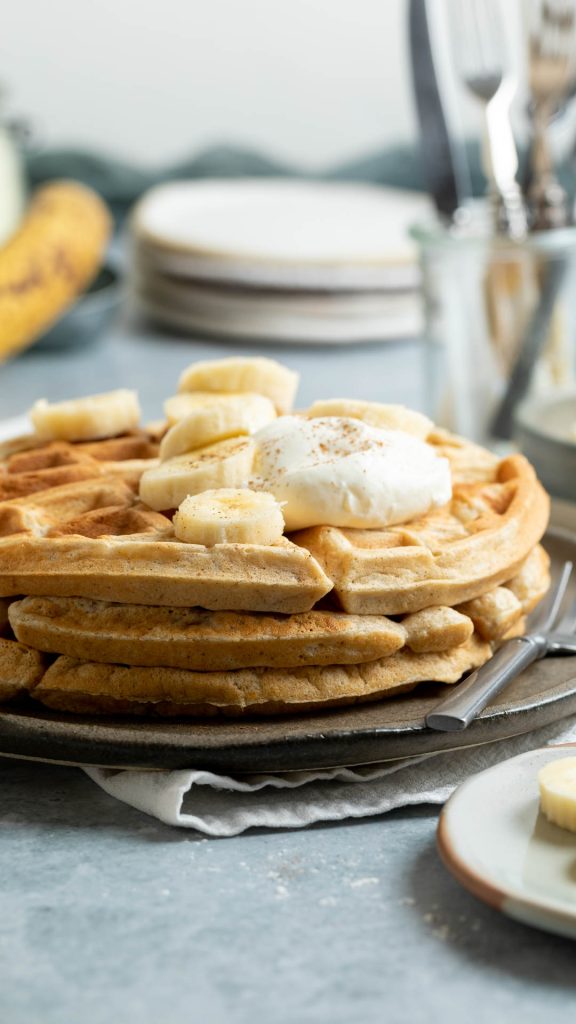 stack on banana waffles topped with yogurt and sliced banana.