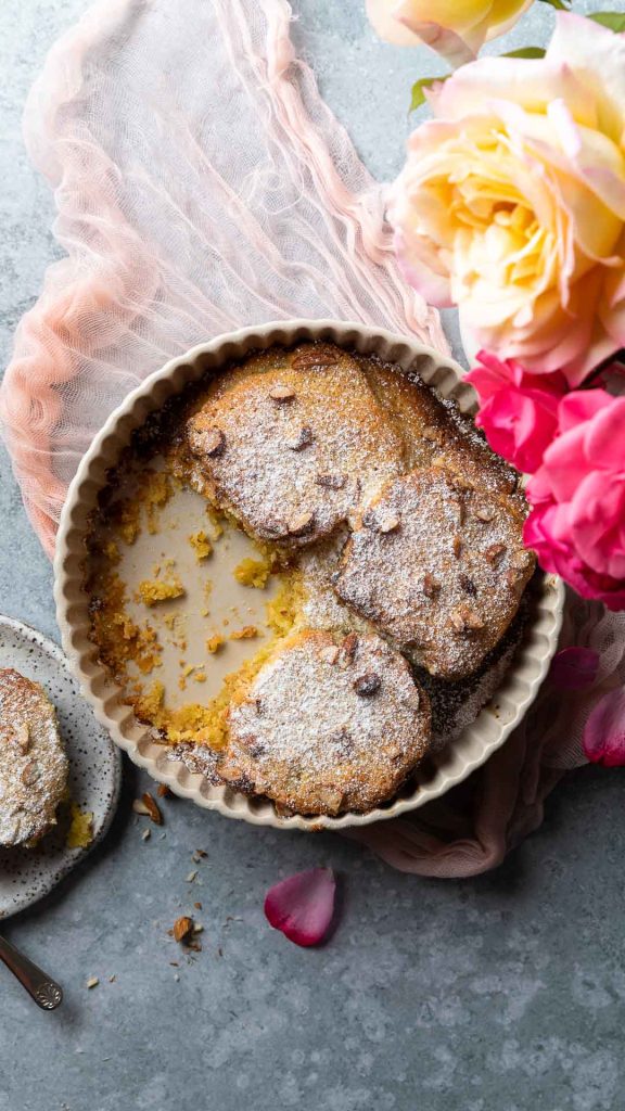 hot cross bun bostock in dish with roses to the side.