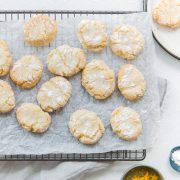 overhead shot of ricciarelli almond biscuits on a cooling rack to show the crackled top
