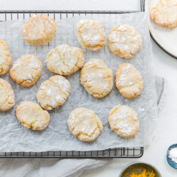 overhead shot of ricciarelli almond biscuits on a cooling rack to show the crackled top