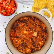 bowl of turkey chilli with corn chips to serve with in the corner