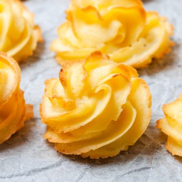 side view of duchess potatos just out of oven to show the golden ridges