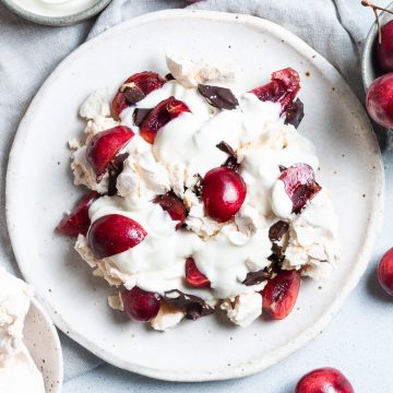 black forest eton mess surrounded by a bowl of cherries and a bowl of chocolate
