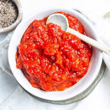 pizza sauce in a white bowl with spoon ready to serve