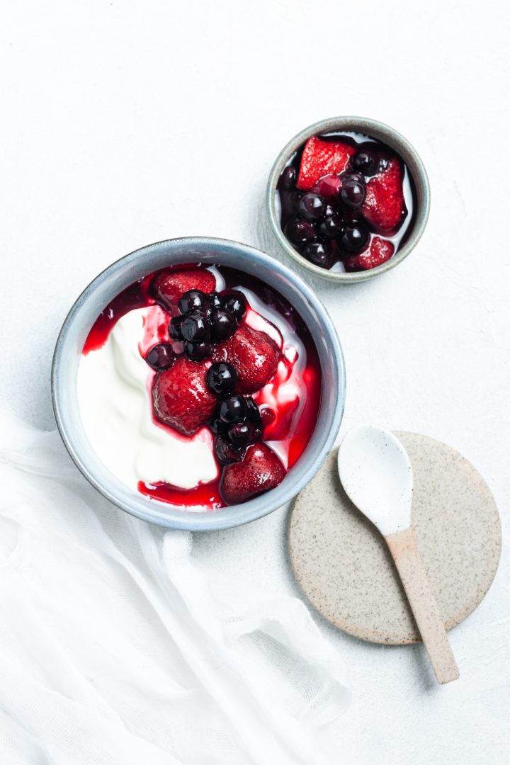 bowl of compote and plain yogurt as serving suggestion, with extra compote on the side