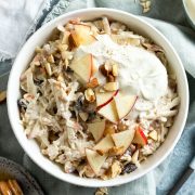 bowl of bircher muesli topped with yogurt and apple