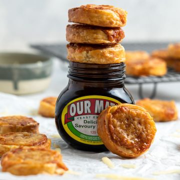 side view of three cheese and marmite pinwheels on top of a Marmite jar