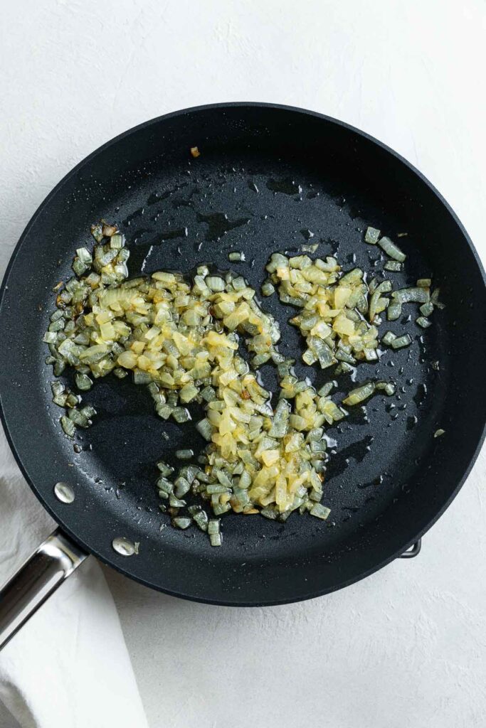 Softened onions in a frying pan.