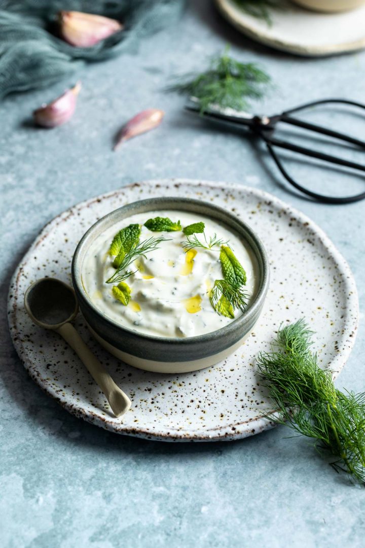 photo of yogurt dip in a bowl drizzled with olive oil for this Haydari recipe