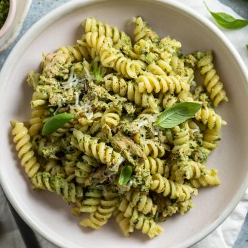 close up overhead of pesto pasta with tuna in a bowl