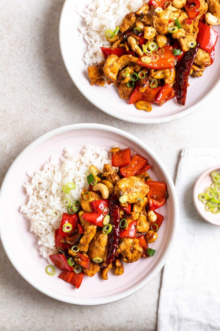 two bowls of Thai chicken with cashews served with rice