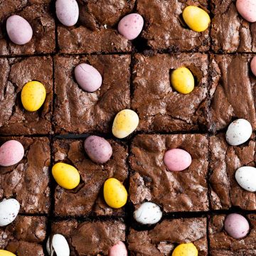 overhead photo of mini egg brownies that have just been cut, to show the mini egg decoration