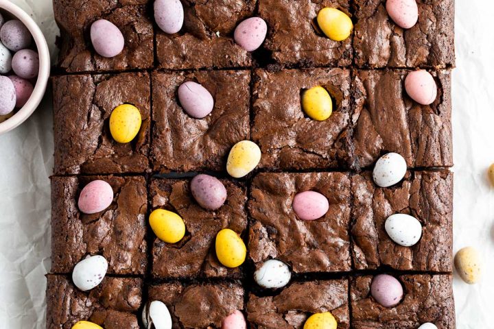 overhead photo of mini egg brownies that have just been cut, to show the mini egg decoration
