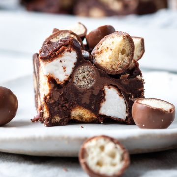 side view of a slice of rocky road with Maltesers to show the Maltesers and marshmallows