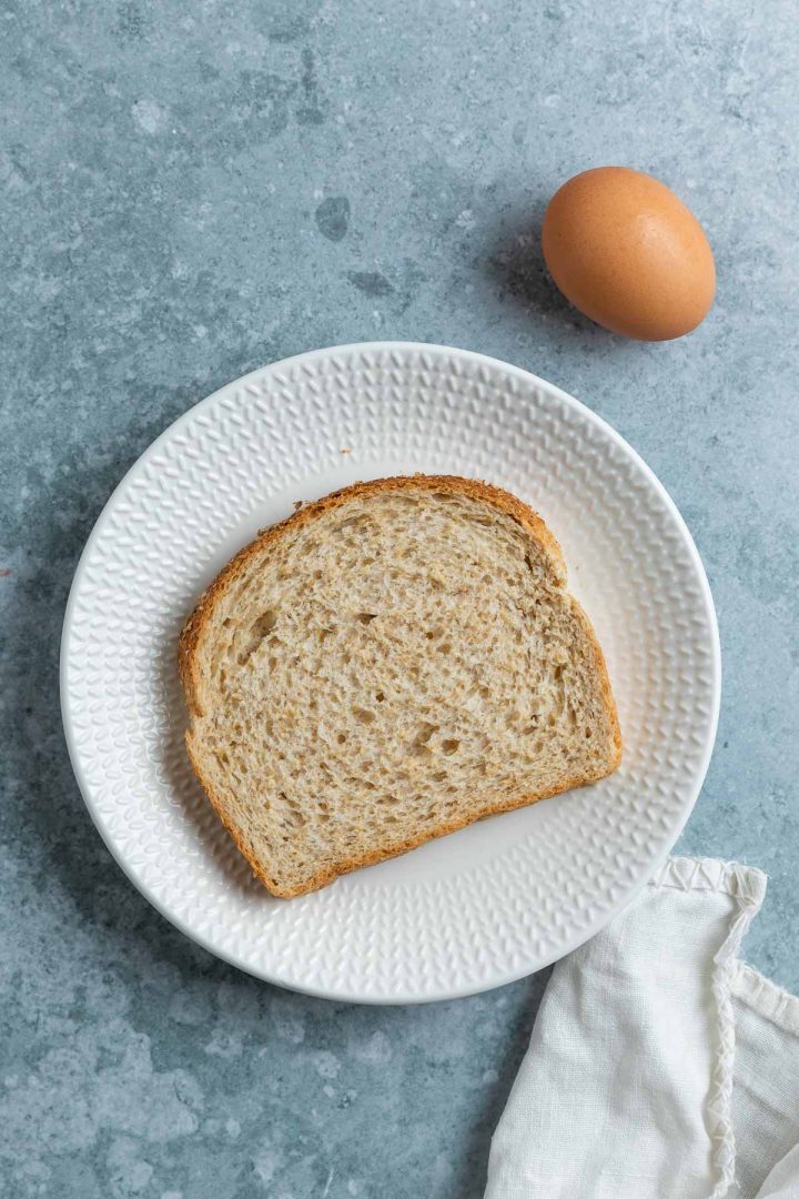 ingredients needed, a slice of wholemeal bread on a plate and one egg