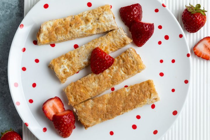 eggy bread for babies cut into fingers and served with strawberries