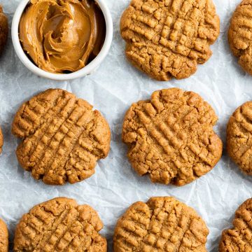 rows of Biscoff cookies with a pot of Lotus Biscoff cpread in the top left corner