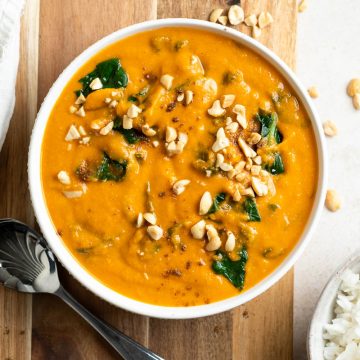 bowl of West African peanut stew Domoda sprinkled with peanuts