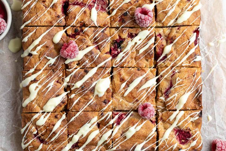 overhead photo of white chocolate and raspberry blondies drizzled with white chocolate