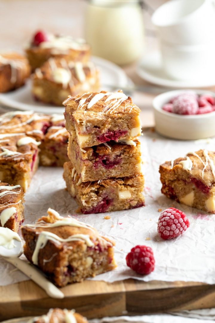 stack of three squares to show the delicious fudgy soft centres and pieces of raspberry and chunks of white chocolate