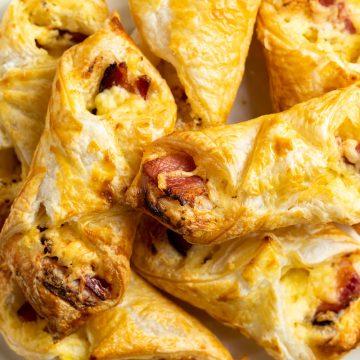 bacon and cheese turnovers on a white plate