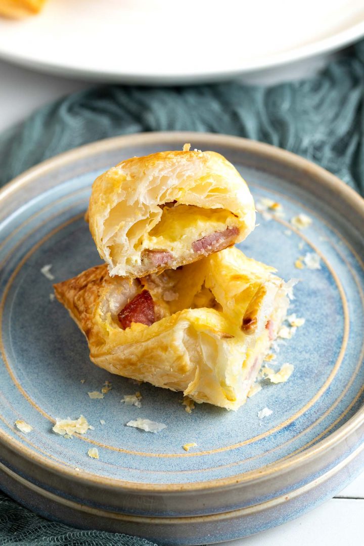 Cut baked pastry wrap to show the crispy pastry and cooked bacon cheese filling