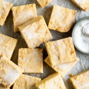 A baking tray of Scottish shortbread squares dusted with sugar