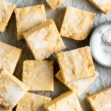 A baking tray of Scottish shortbread squares dusted with sugar