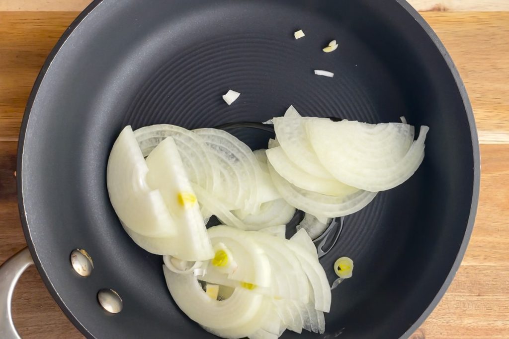 sliced onions in a frying pan