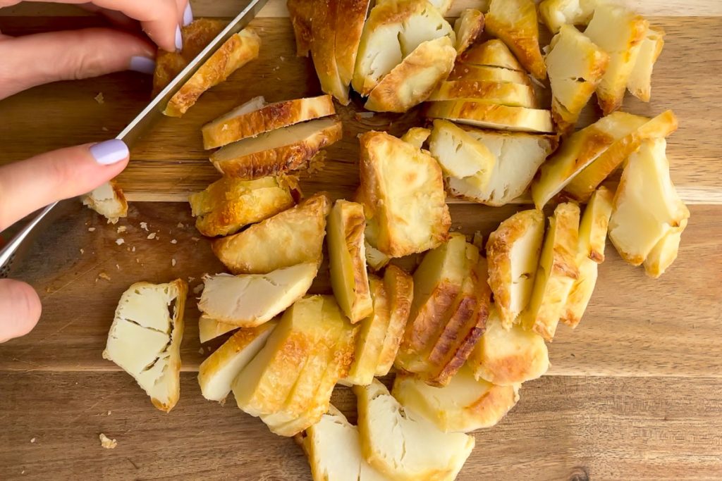 Chopping the cold roast potatoes into slices