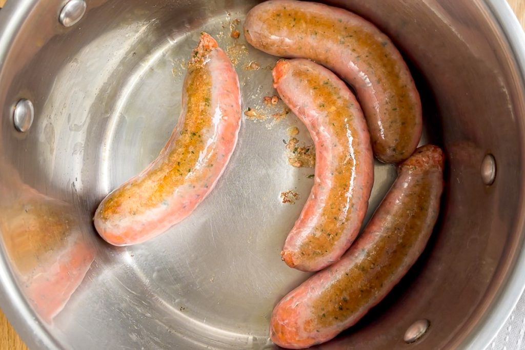 browning the sausages in the saucepan