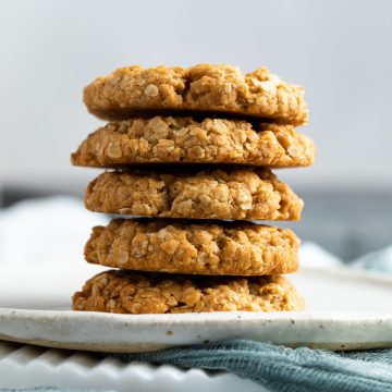 Stack of 5 oat biscuits on white plate