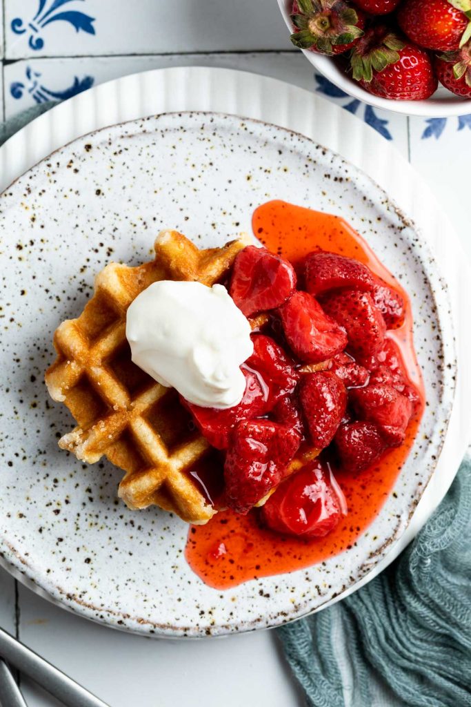 strawberry compote, waffles and plain yogurt on a plate ready to eat.