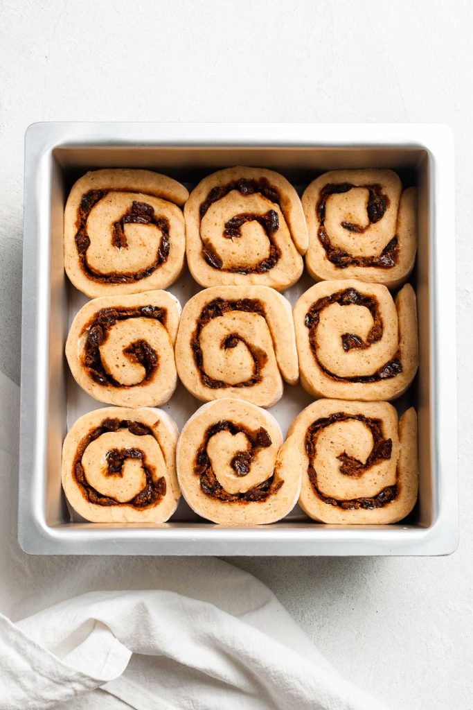 scrolls in baking tin after their rise, now touching.