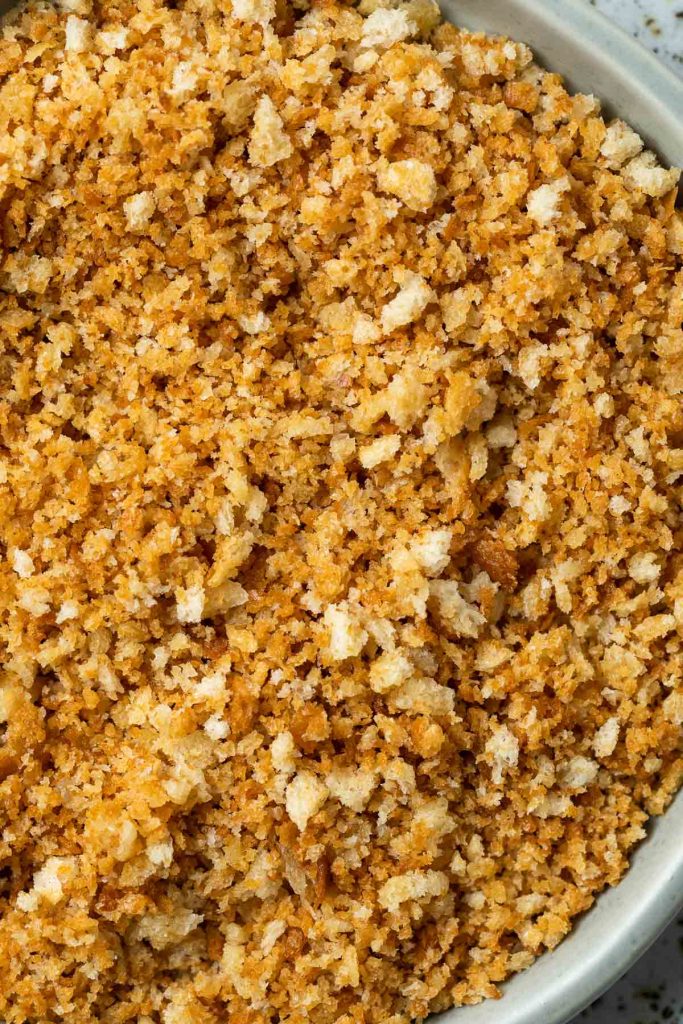 close up of crispy flavoured breadcrumbs in a dish.