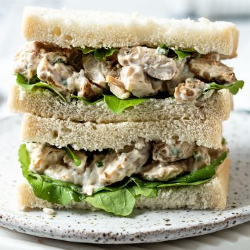 chicken mayo sandwich cut into 2 and placed on a plate.
