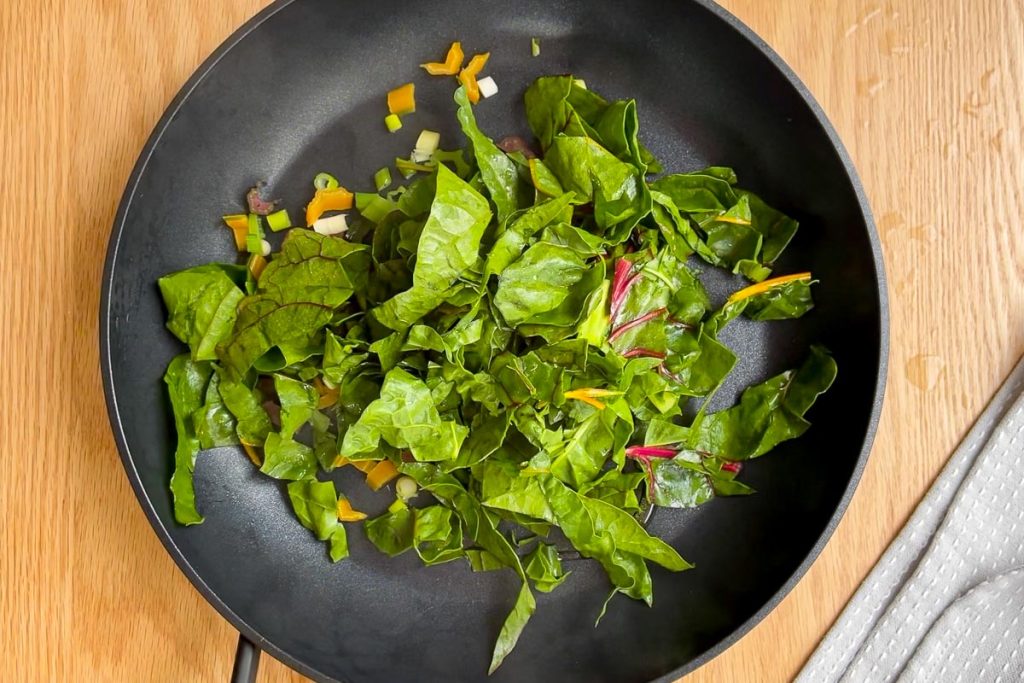 chopped silverbeet leaves in large frying pan.