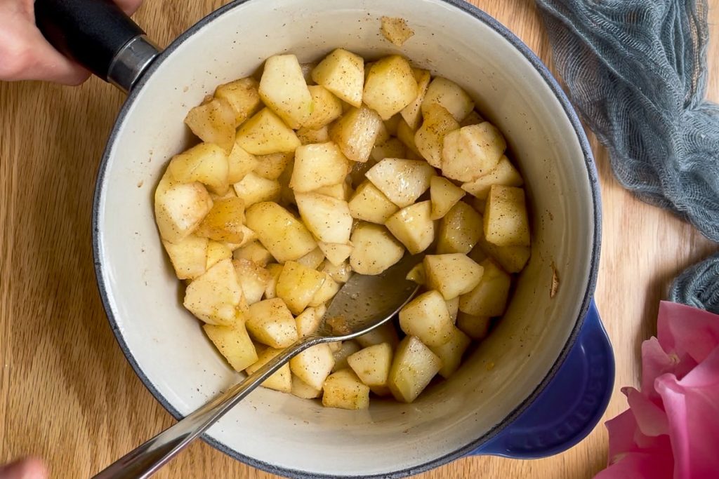 Softened apples in a saucepan.